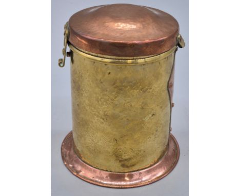 An Arts and Crafts Copper and Brass circular covered caddy with beaten body and showing studs. 14cm high. 