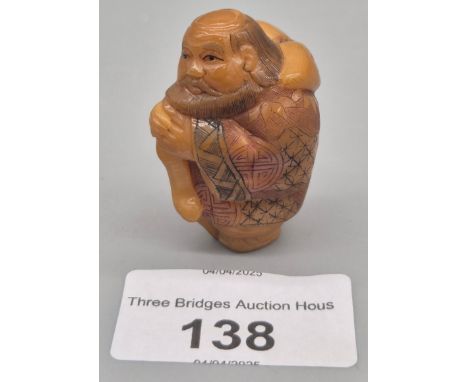A Japanese hand carved tagua nut netsuke figurine, with Japanese signature incised on underside