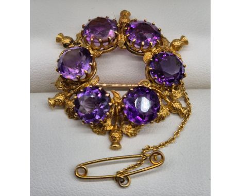 Antique 15ct yellow gold and amethyst gem stone brooch. Brooch is set with six featured round cut amethysts and gold thistle 