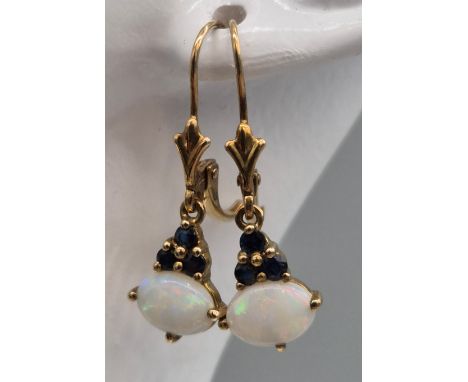 Two pairs of 9ct yellow gold and opal stone earrings; Pair of opal and diamond earrings and a pair of opal and sapphire earri