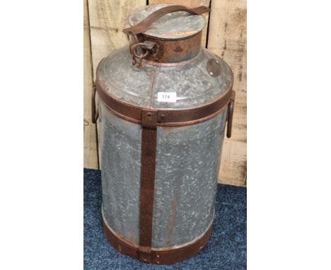An early 20th Century well patinated milk churn and cover with metal “Country Dairies” plaque. 64cm high. 