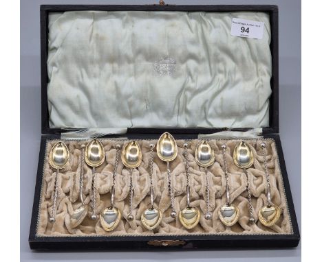 Boxed set of twelve 830 grade silver gilt tea spoons. All having barley twist stems finished with a sphere finial. 130.44gram