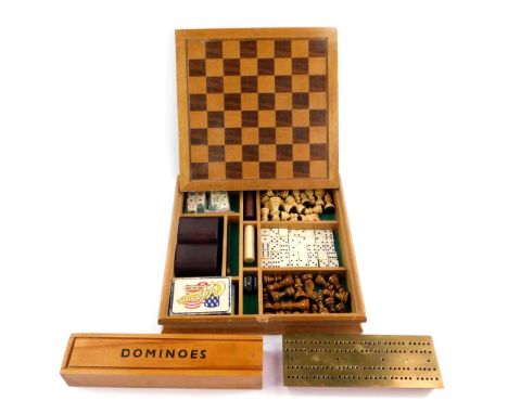 A wooden cased games compendium, containing chess, dominoes, cards and poker die, the box with chessboard top, 30cm Dia, toge