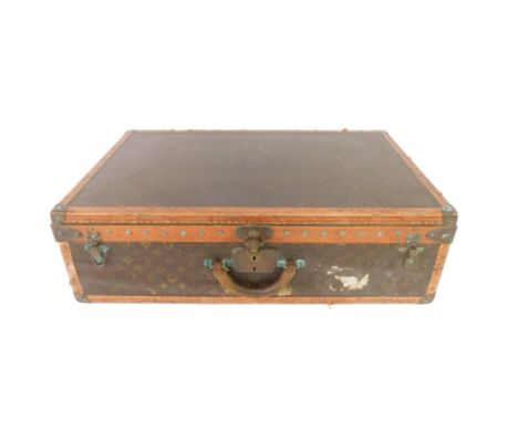 A Louis Vuitton cabin trunk, early 20thC with monogrammed brown canvas, monogrammed tan edge and brass caps and studded bands