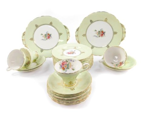 An early 20thC Aynsley porcelain part tea service, decorated with floral sprays against an eau de nil ground, gilt heightened