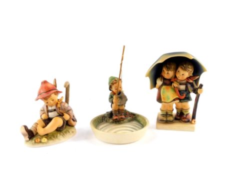 A Hummel figure modelled as Stormy Weather, first issue figure modelled as Time Out, and a dish modelled as Just Fishing, all