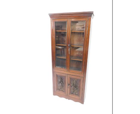 A Victorian mahogany cupboard bookcase, the outswept pediment over two glazed doors, opening to reveal three shelves, above a