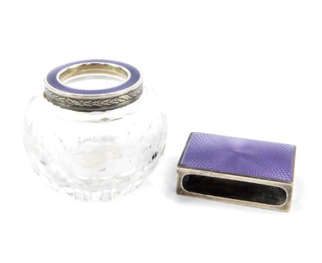 A Continental lilac guilloche enamel match sleeve, set in white metal, together with a cut glass match holder, engraved with 