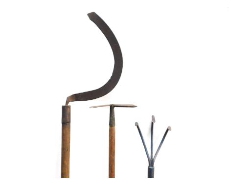 Three vintage garden tools, comprising scythe, weed puller and hoe.