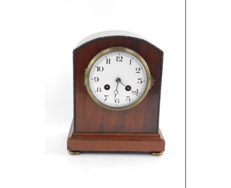 An early 20thC mahogany cased mantel clock, circular enamel dial bearing Arabic numerals, eight day movement, with bell strik