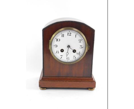 An early 20thC mahogany cased mantel clock, circular enamel dial bearing Arabic numerals, eight day movement, with bell strik