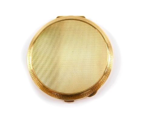 A 9ct gold circular cased compact, with engine turned decoration, opening to reveal an internal mirror and powder recess, Tur