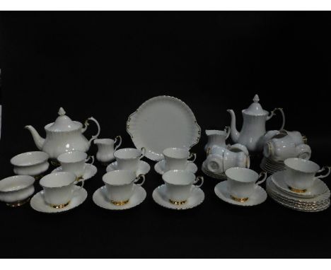 A Royal Albert porcelain part tea and coffee service decorated in the Val D'or pattern, comprising tea pot, coffee pot, bread