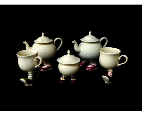 Two Carltonware lustre pottery 'Walking' teapots, sugar basin and cover, and two mugs. (5)