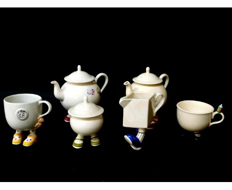 Two Carltonware lustre pottery 'Walking' teapots, sugar basin with cover, a pirate mug and another "I am 18", and a milk jug.