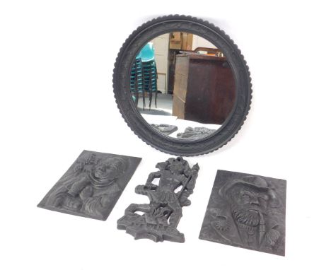 A cast iron circular wall mirror, 49cm Dia., a pair of cast iron wall plaques decorated in relief with a monk drinking wine f