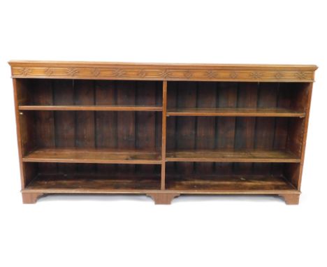 A late Victorian mahogany open bookcase, with a blind fret work frieze over four adjustable shelves, raised on bracket feet, 