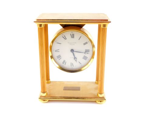 A Garrard and Company late 20thC gold plated brass mantel clock, of portico form, with fluted columns, circular dial bearing 