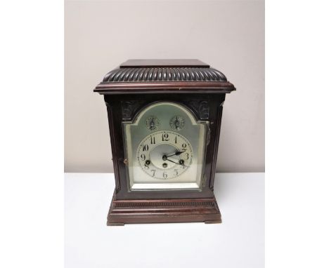 An early 20th century German bracket clock with pendulum and key. 