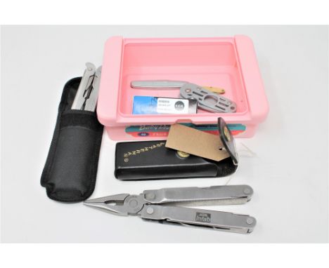 A Leatherman Super tool in pouch, together with further pocket knives and multi tools