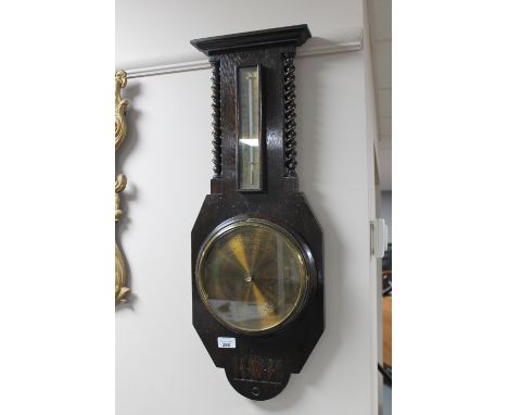 An oak barley twist aneroid barometer with brass dial 