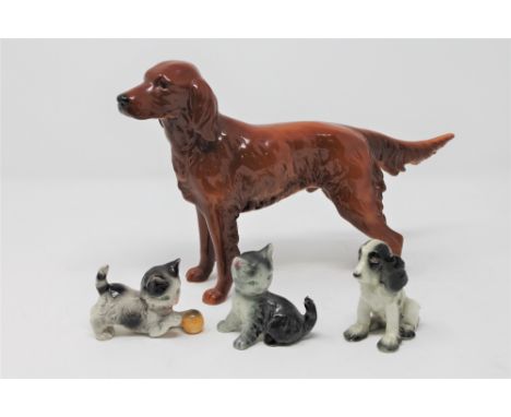 A Goebel figure of a setter, height 17.5cm, together with three further German pottery figures of two kittens and a puppy