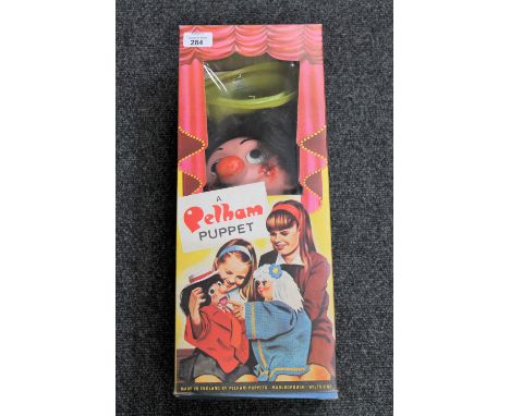 A boxed Pelham puppet - Supy CONDITION REPORT: Mouth opens correctly. Clothes with some light marks. Plastic hat with several