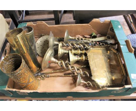 A box containing assorted brassware, including three trench art ammunition shells, barley twist candle sticks, toasting forks