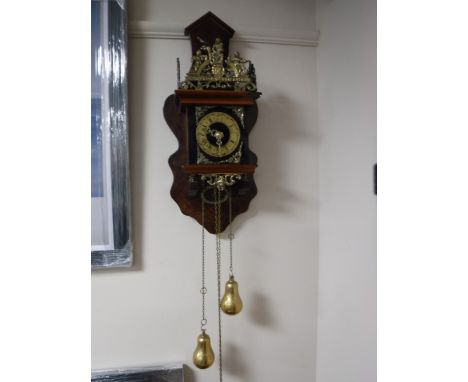 A reproduction continental weight driven wall clock with brass weights