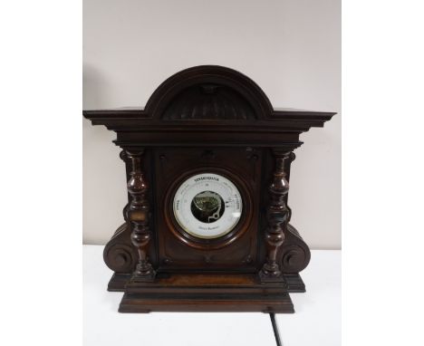 A Victorian aneroid barometer in carved mahogany case. 