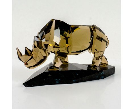 Beautiful faceted crystal figurine modeled as rhinoceros with smoky brown tint standing on a black granite base.Part of the S