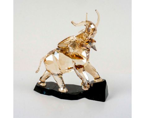 Beautiful faceted crystal figurine modeled as trumpeting elephant with light golden brown tint and black granite base.Part of