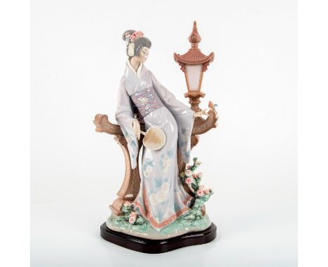 Glossy finish porcelain figure modeled Woman dressed in traditional Japanese attire next to lamp post. Lladro backstamp. This