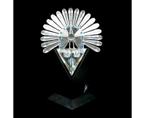 Limited edition sculpture with booklet. Peacock with Capri-blue stones; silver feet and head. Artist signed black base.Swarov