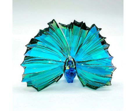 Faceted crystal figurine modeled as a gorgeous peacock with blue and green coloration and mirror finish to rear.Made exclusiv