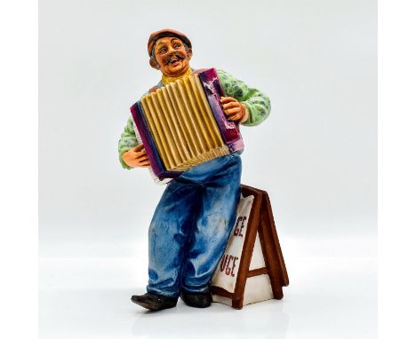 Model No. 2260. Fine China, matte finish. Modeled as a man playing the accordion beside a Moulin Rouge sign.Royal Doulton bac