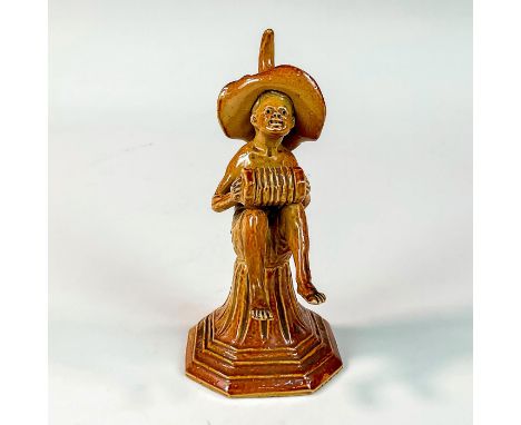 Stoneware figure part of the Merry Musicians series. Modeled as a seated boy gracefully playing the concertina instrument. Do
