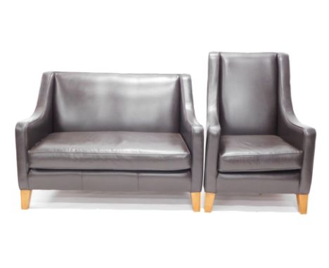 A Multi York black leather sofa suite, comprising two seater sofa and armchair bearing label. 