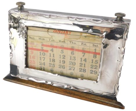 A George III desk calendar, in a stained pine ebonised frame, with a fluted silver front, and glass panel, Birmingham 1925, 1