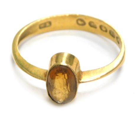 A 22ct gold dress ring, converted from a wedding band with central citrine, in rub over setting, ring size O½, 2.5g all in.