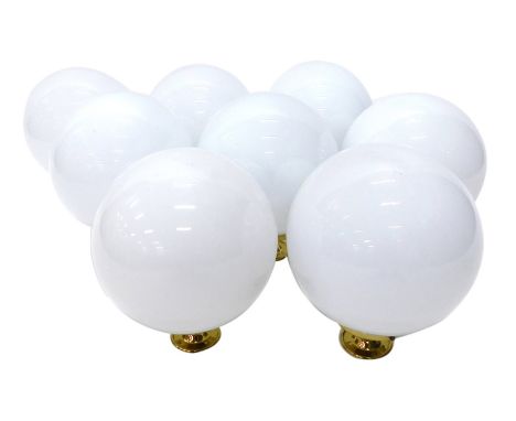 Eight Christopher Wray globe opaque glass ceiling lights, with brass hangings, 31cm high.