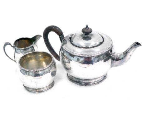 An Elkington &amp; Co silver three piece tea set, in the arts and crafts style, with ebonised handle and balled border, Birmi