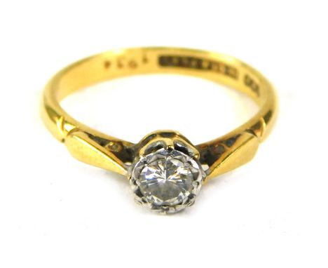 A diamond solitaire ring, the round brilliant cut diamond, in rub over setting, approx 0.25ct, in a raised basket, on a yello