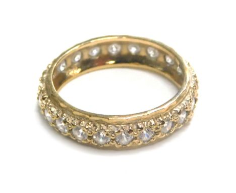 A 9ct gold cz set eternity ring, ring size M½, 2.4g, and a small piece of scrap gold.