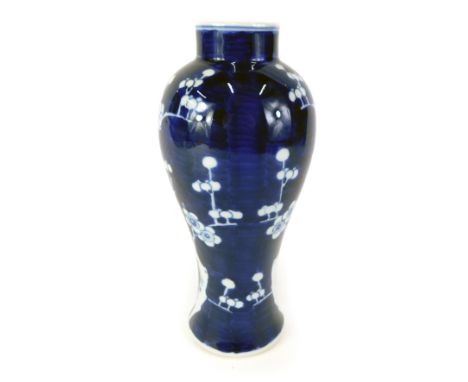 A 20thC Chinese blue and white vases, on a blue ground with white blossom detail, with two ring stamped to underside, 27cm hi