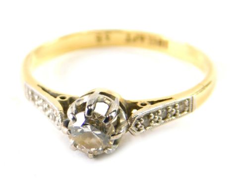 An 18ct gold platinum and diamond dress ring, claw set with single stone, flanked by small white stones to the shoulders, mar