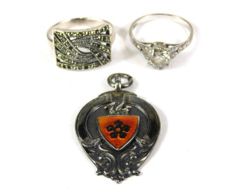 A group of silver costume jewellery, comprising a silver and marcasite dress ring, a silver and paste stone set solitaire rin