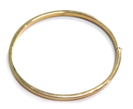 A 9ct gold hinged bangle, of plain design, 7cm wide, 4.9g.