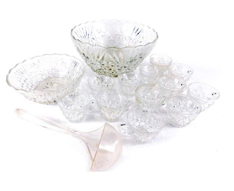 A pressed glass punch bowl, plastic ladle, and various hanging cups.