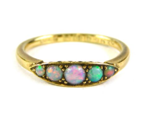 An 18ct gold opal gypsy ring, the central shape set with five opals, on a plain band, ring size L½, 2.6g all in, boxed. 